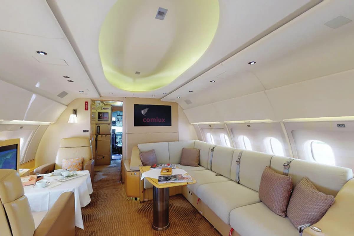 ACJ319 9H-LIV lounge with dining table set for a meal