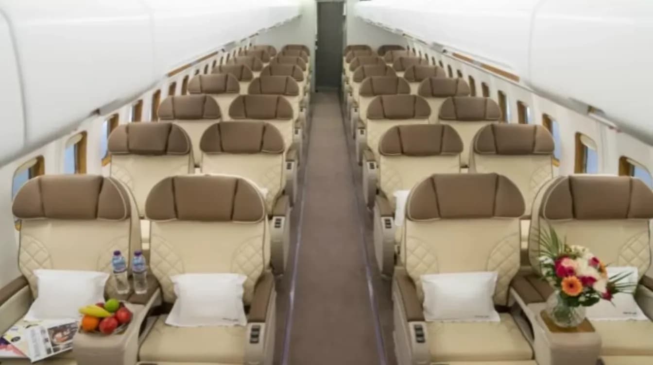 Charter airliner cabin in 2-2 team configuration with cream leather seats
