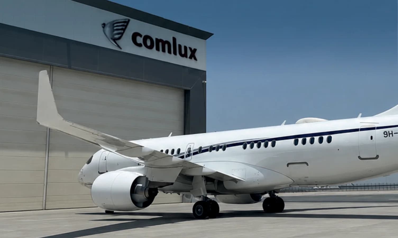 Airbus ACJ TwoTwenty 9H-818TG on the apron in front of a hangar