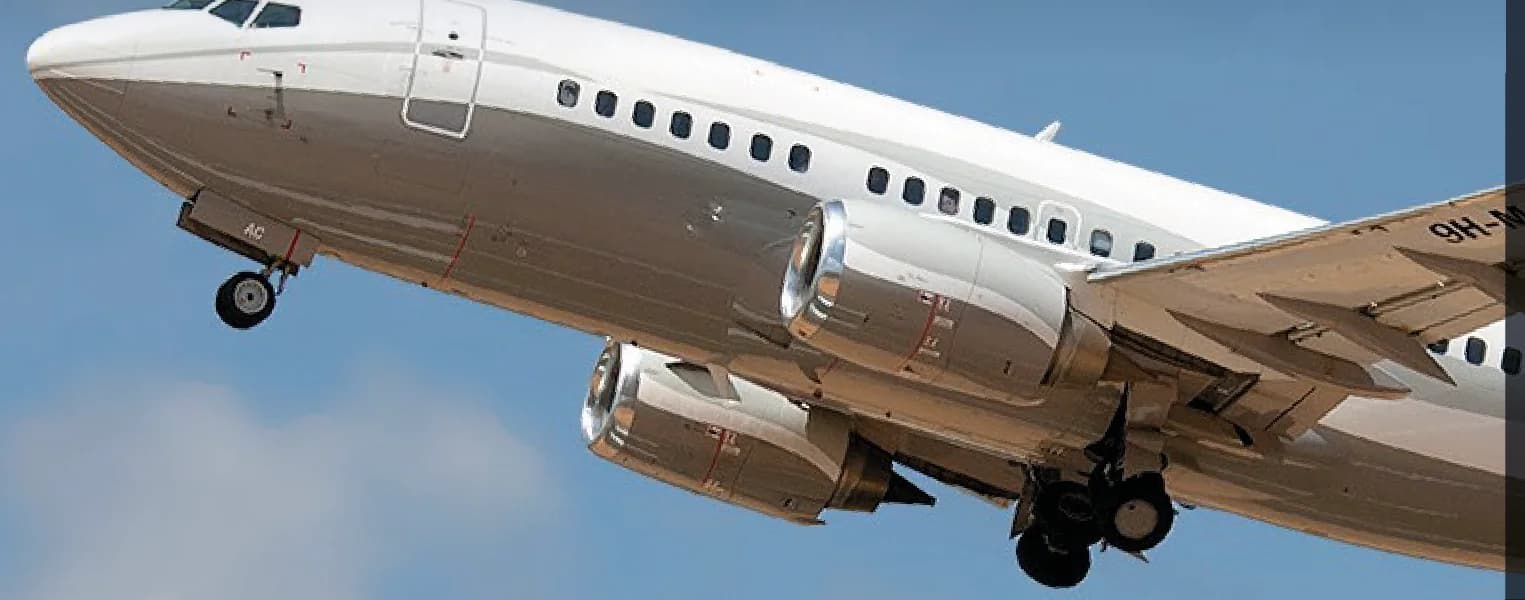 Boeing 737-500 BBJ 9H-MAC climbing after take-off