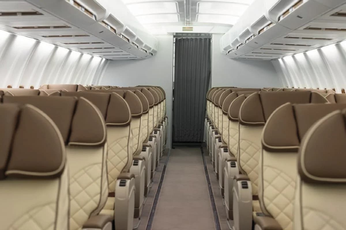 737-500 BBJ 9H-MAC cabin aisle with rows of leather seats