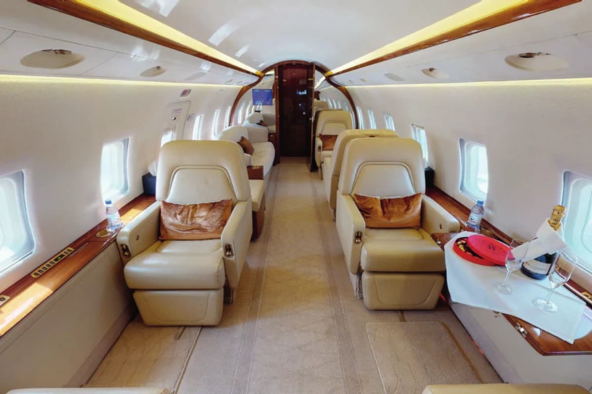 Challenger 604 UP-CL602 club seats with table set for a meal